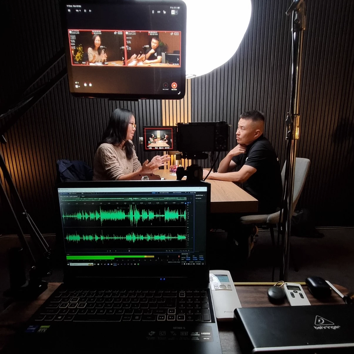Man and woman recording at the VV Studios podcast studio table in Sydney